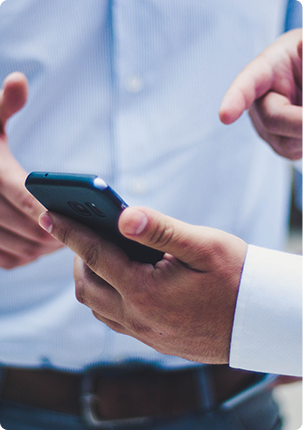 Two people using the HOST app builder on a smartphone.