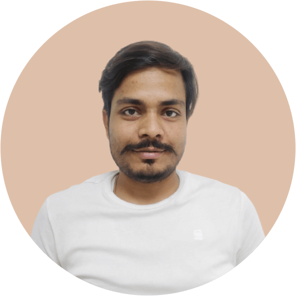 Portrait of a man with dark hair and a mustache wearing a white t-shirt against a beige background.