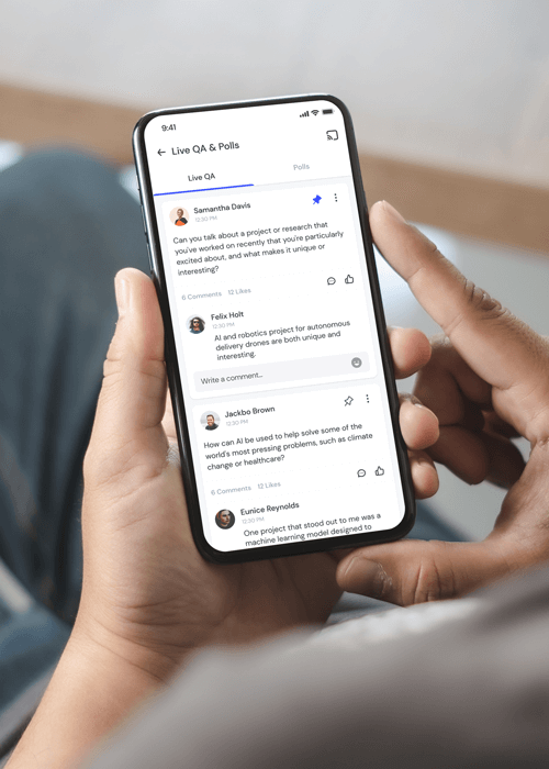 Hand holding smartphone displaying a live Q&A and polls app with comments about AI projects and technology.