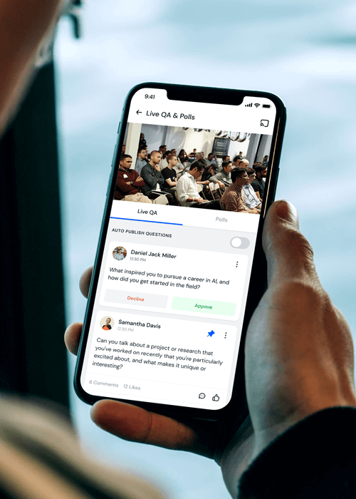 Person holding a smartphone displaying a live Q&A and polls app with questions about AI career inspiration and research projects.