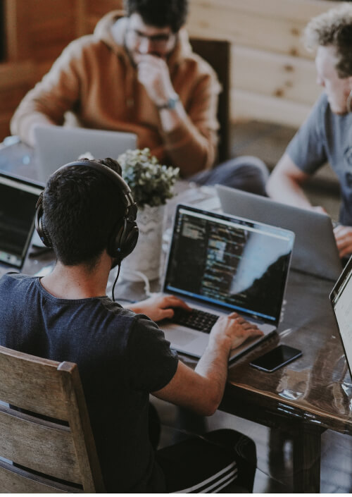 a man sitting on a chair and working on a laptop