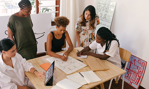  group of people planning & brainstorming on a worktable