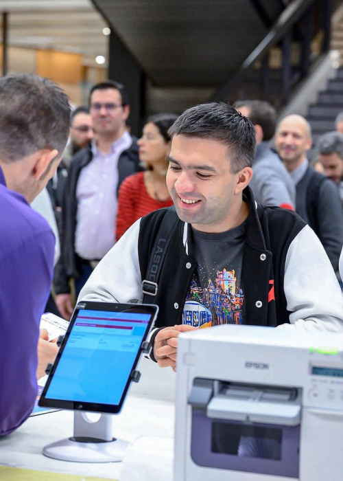a man looking to print or get his event badge in an event