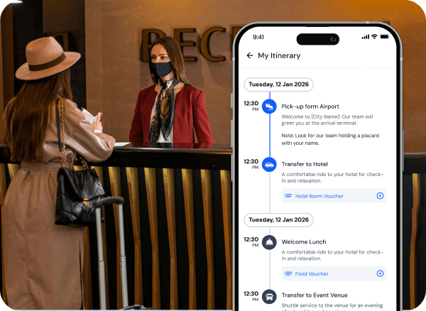 Woman with suitcase checking in at reception desk with attendant in mask, alongside phone screen showing a travel itinerary app with airport pick-up, hotel transfer, lunch, and event venue transfer.